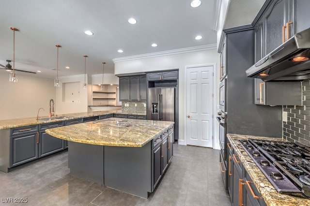 kitchen featuring crown molding, sink, appliances with stainless steel finishes, decorative light fixtures, and a kitchen island