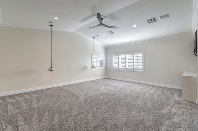 spare room featuring carpet, ceiling fan, crown molding, and vaulted ceiling