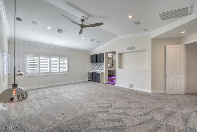 unfurnished living room with ceiling fan, carpet floors, lofted ceiling, and ornamental molding