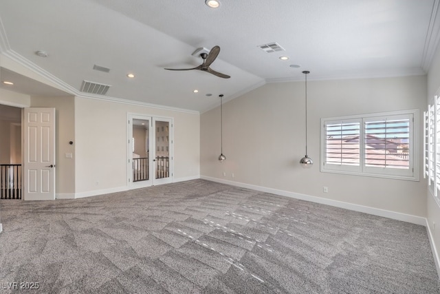 empty room featuring ceiling fan, crown molding, carpet floors, and lofted ceiling