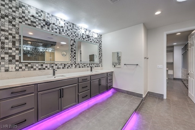 bathroom with tile patterned floors, backsplash, and vanity