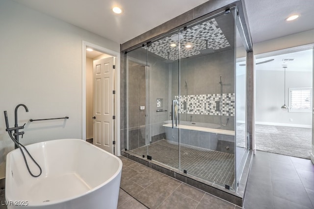 bathroom featuring tile patterned flooring and separate shower and tub