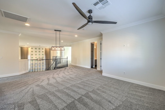 carpeted spare room with ceiling fan and crown molding