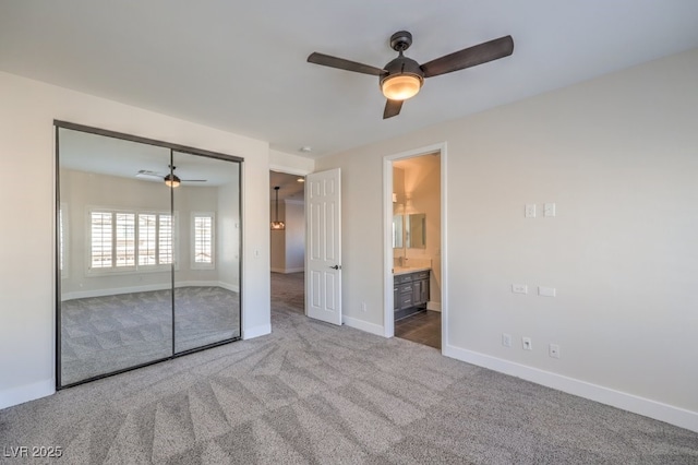 unfurnished bedroom featuring connected bathroom, ceiling fan, a closet, and carpet floors