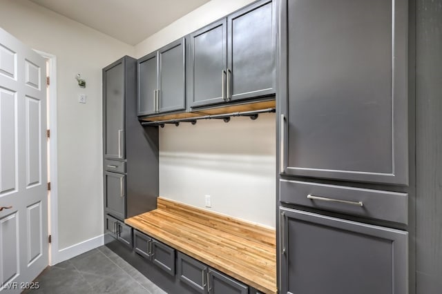 mudroom with dark tile patterned flooring