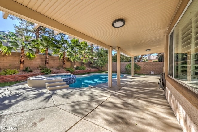 view of patio / terrace with a pool with hot tub