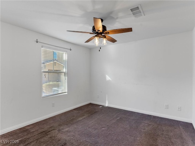 unfurnished room featuring ceiling fan and dark colored carpet