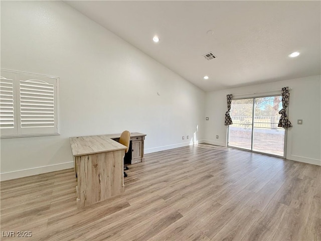 unfurnished living room featuring high vaulted ceiling and light hardwood / wood-style flooring