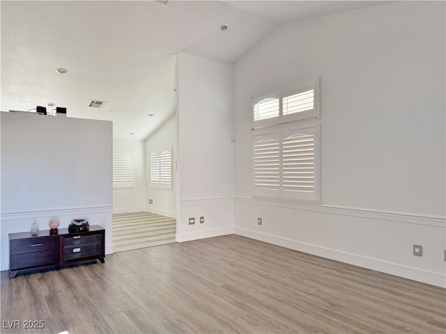 living room featuring hardwood / wood-style flooring and lofted ceiling