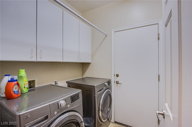 laundry area featuring cabinets and washing machine and dryer