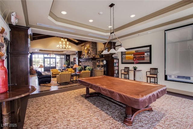 playroom with crown molding, an inviting chandelier, a tray ceiling, a fireplace, and pool table