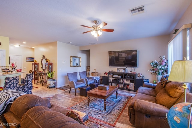 living room with light hardwood / wood-style floors and ceiling fan