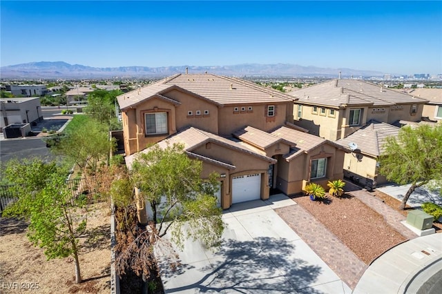 view of front of property featuring a mountain view and a garage