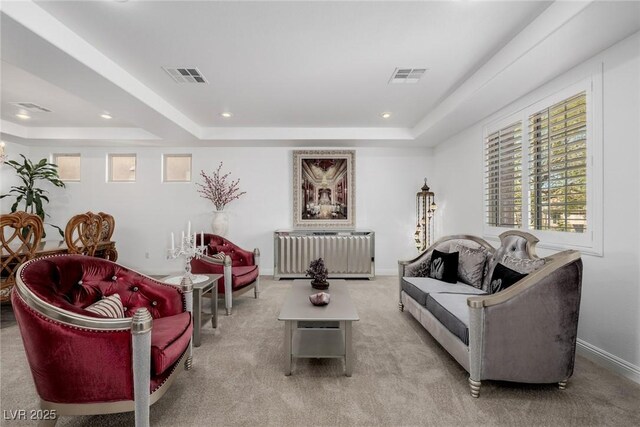 carpeted living room featuring a raised ceiling and radiator