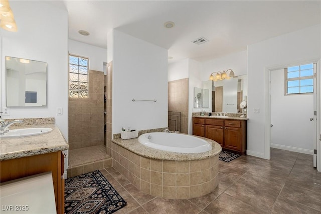 bathroom featuring tile patterned flooring, vanity, and separate shower and tub