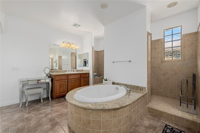 bathroom with tile patterned floors, vanity, and separate shower and tub