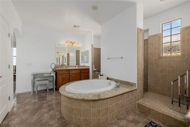 bathroom featuring vanity and independent shower and bath