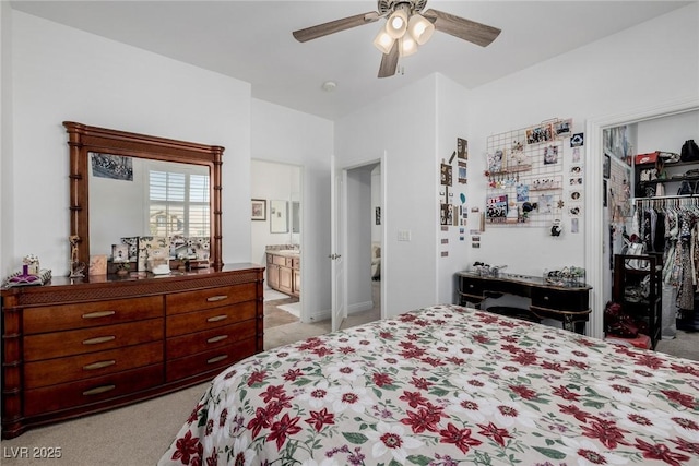 bedroom featuring ceiling fan, light colored carpet, connected bathroom, and a closet