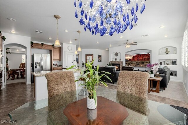 dining room with tile patterned floors, ceiling fan, and sink