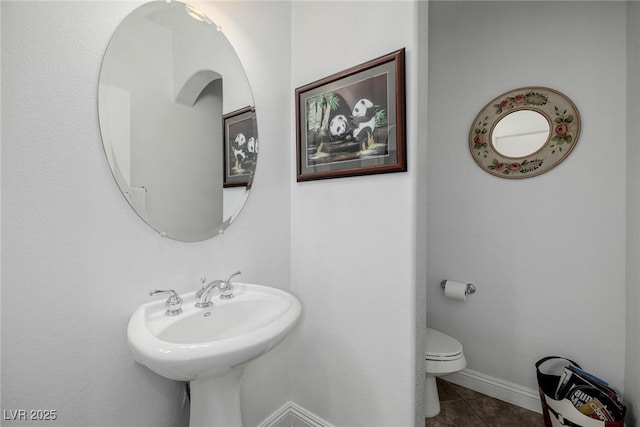 bathroom with tile patterned flooring and toilet