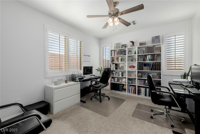 carpeted home office with ceiling fan