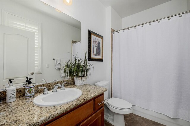 full bathroom with tile patterned floors, shower / tub combo with curtain, vanity, and toilet