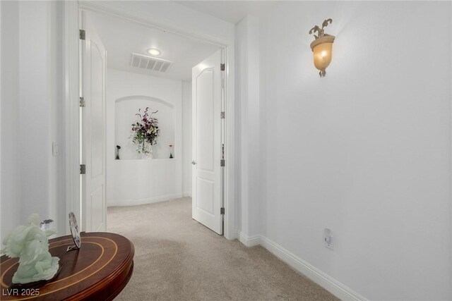 hallway with light colored carpet