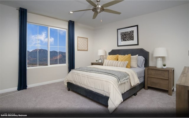 carpeted bedroom with a mountain view and ceiling fan