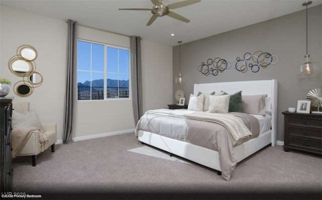 bedroom featuring carpet flooring, ceiling fan, and a mountain view