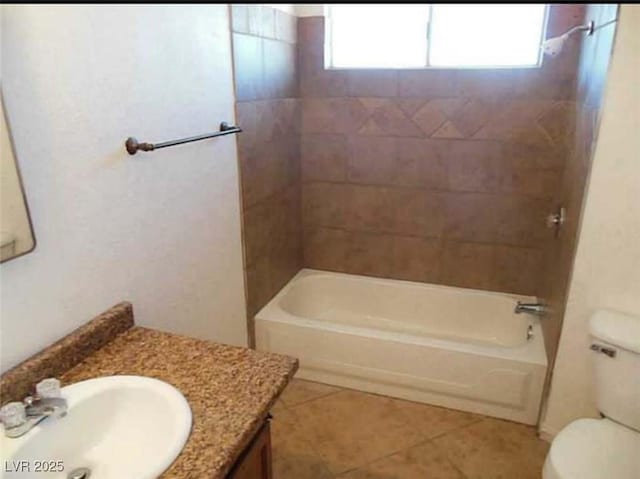 full bathroom with toilet, tiled shower / bath combo, tile patterned flooring, and vanity