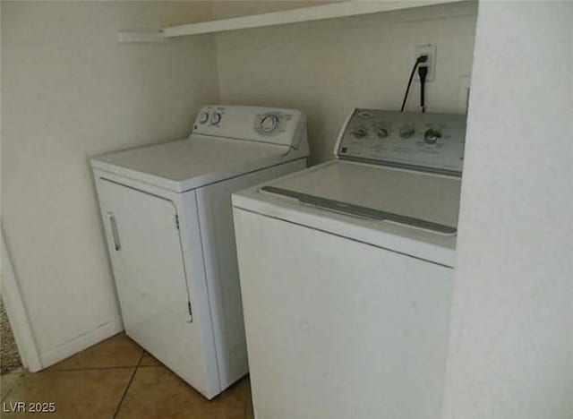 laundry area with washing machine and dryer and light tile patterned flooring