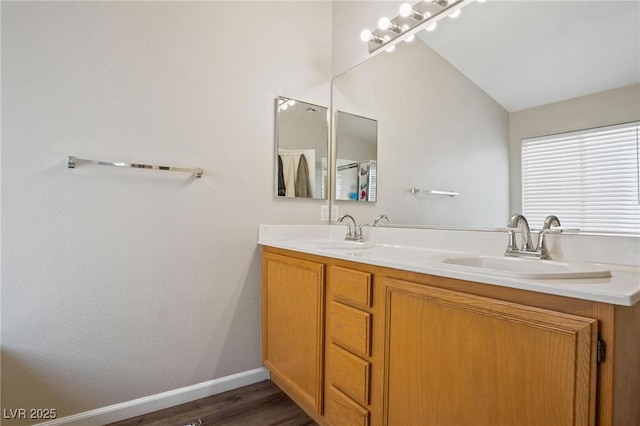 bathroom with vanity, lofted ceiling, and hardwood / wood-style flooring