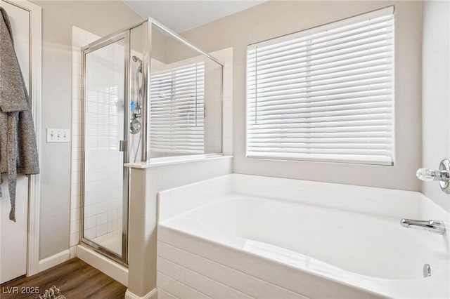 bathroom with hardwood / wood-style floors and separate shower and tub