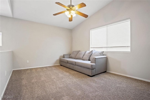 living room featuring ceiling fan, lofted ceiling, and carpet floors