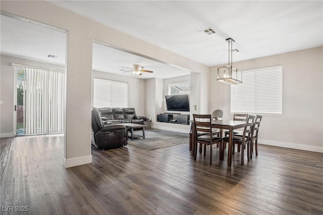 dining room with dark hardwood / wood-style flooring and ceiling fan