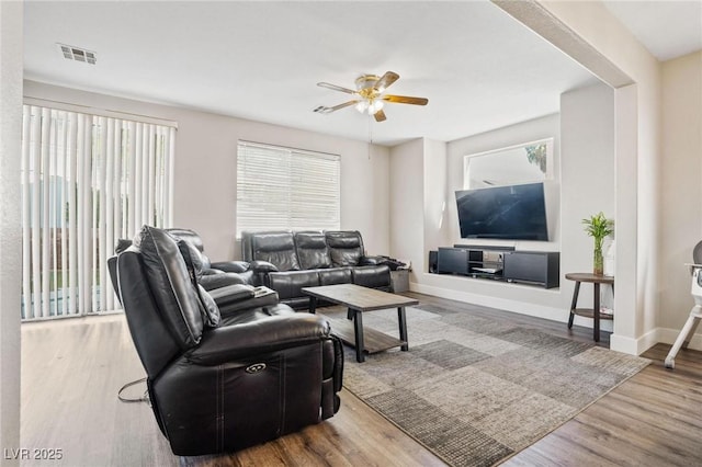 living room with hardwood / wood-style floors and ceiling fan