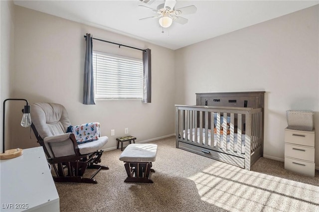 bedroom featuring ceiling fan, carpet, and a crib