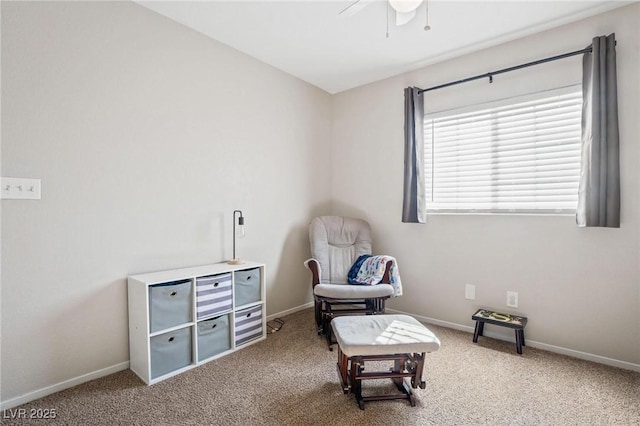 living area with carpet and ceiling fan