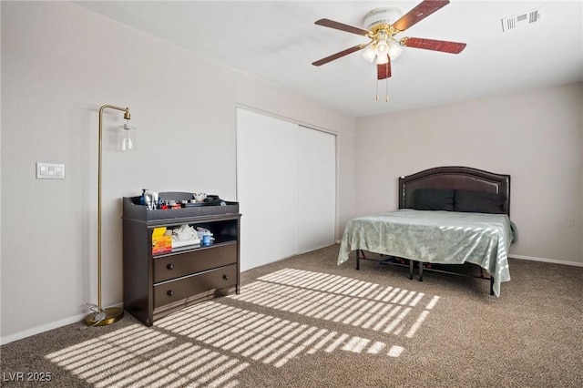 bedroom featuring carpet, ceiling fan, and a closet