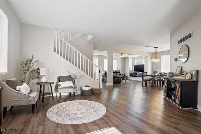 living room featuring dark hardwood / wood-style floors, an inviting chandelier, and plenty of natural light