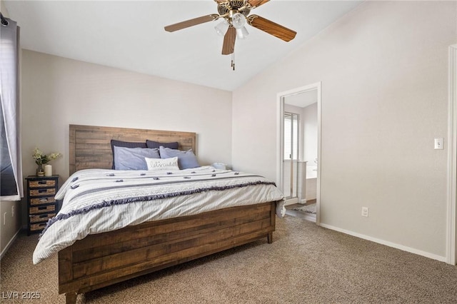 bedroom with ceiling fan, ensuite bath, carpet floors, and vaulted ceiling