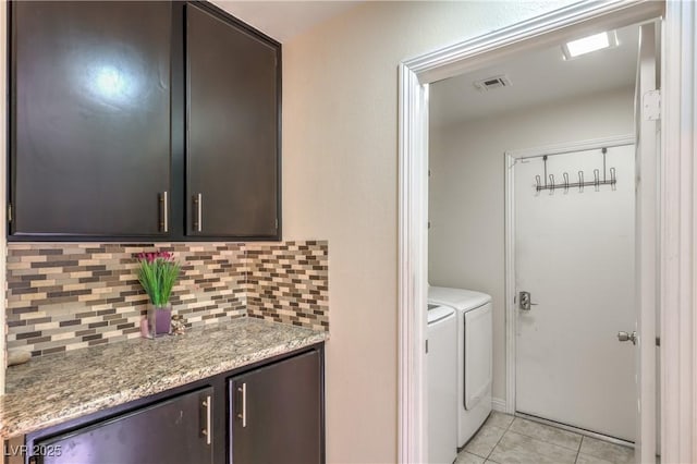 washroom featuring separate washer and dryer and light tile patterned flooring