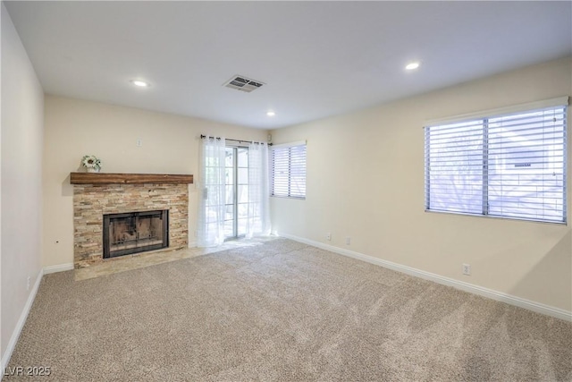 unfurnished living room featuring a fireplace and light carpet