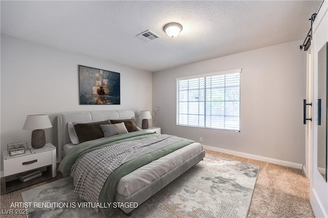 carpeted bedroom with a textured ceiling and a barn door