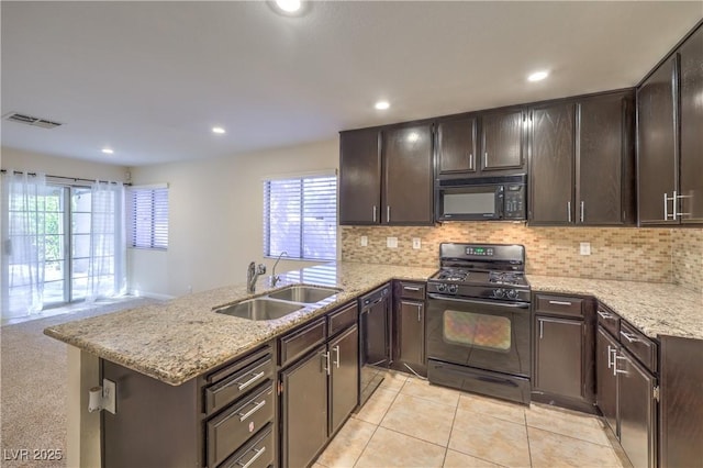 kitchen featuring black appliances, sink, decorative backsplash, dark brown cabinets, and a healthy amount of sunlight