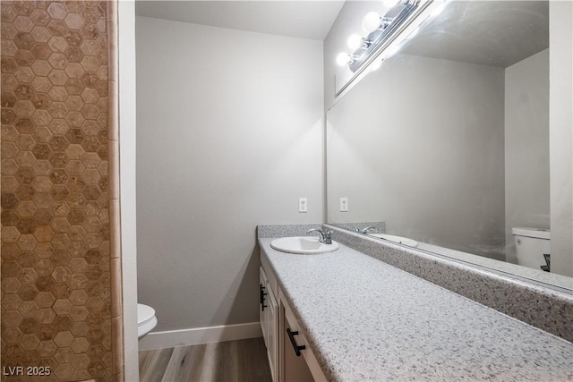 bathroom with vanity, wood-type flooring, and toilet