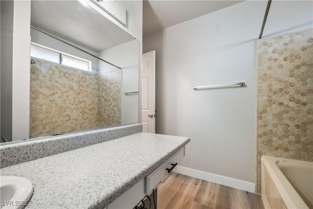 bathroom featuring hardwood / wood-style floors, vanity, and bathtub / shower combination