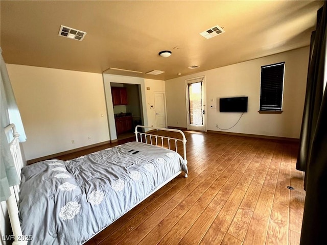 bedroom with hardwood / wood-style floors