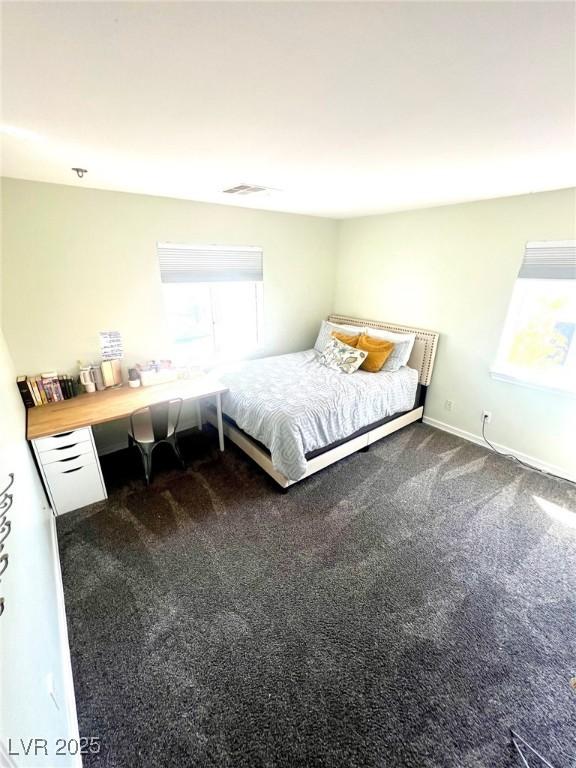 unfurnished bedroom featuring dark colored carpet