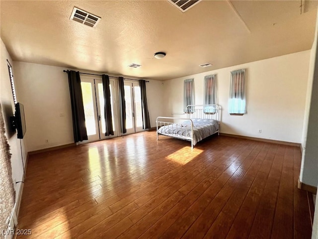 unfurnished bedroom with hardwood / wood-style flooring